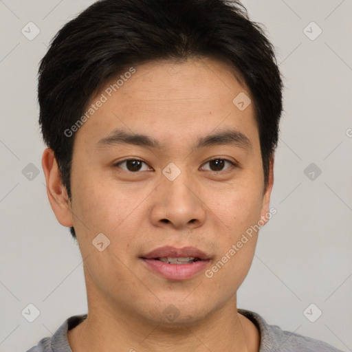 Joyful asian young-adult male with short  brown hair and brown eyes