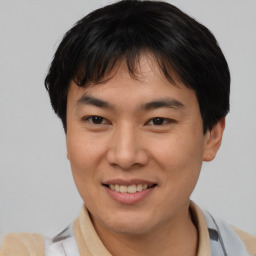 Joyful asian young-adult male with short  brown hair and brown eyes