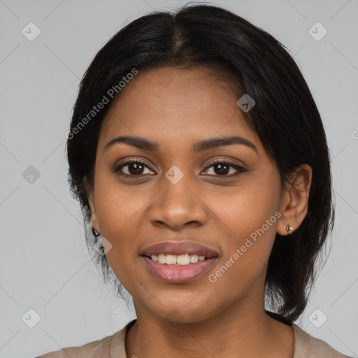 Joyful black young-adult female with long  black hair and brown eyes