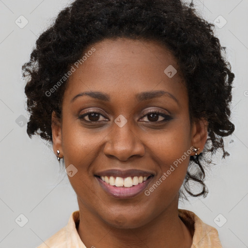 Joyful black young-adult female with long  brown hair and brown eyes