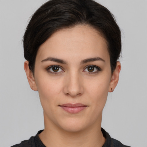 Joyful white young-adult female with short  brown hair and brown eyes