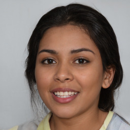 Joyful latino young-adult female with medium  brown hair and brown eyes