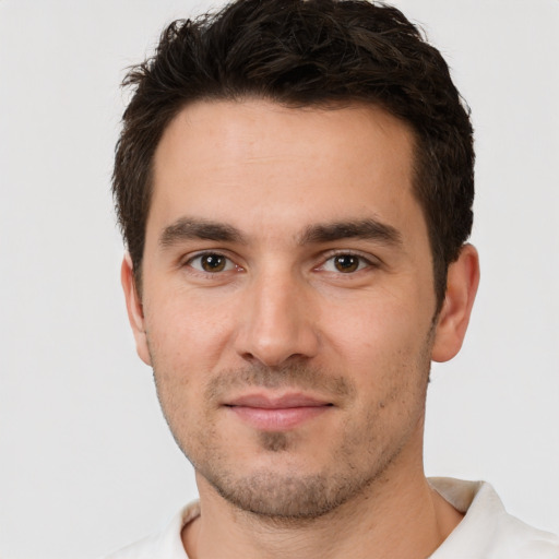 Joyful white young-adult male with short  brown hair and brown eyes