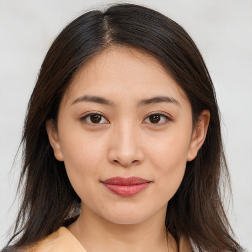 Joyful asian young-adult female with medium  brown hair and brown eyes