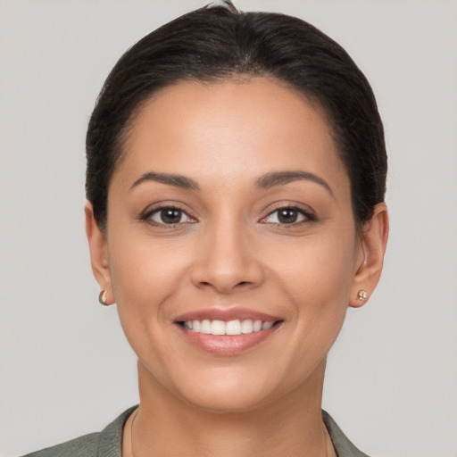 Joyful latino young-adult female with short  brown hair and brown eyes