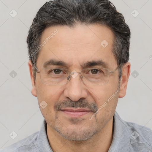 Joyful white adult male with short  black hair and brown eyes