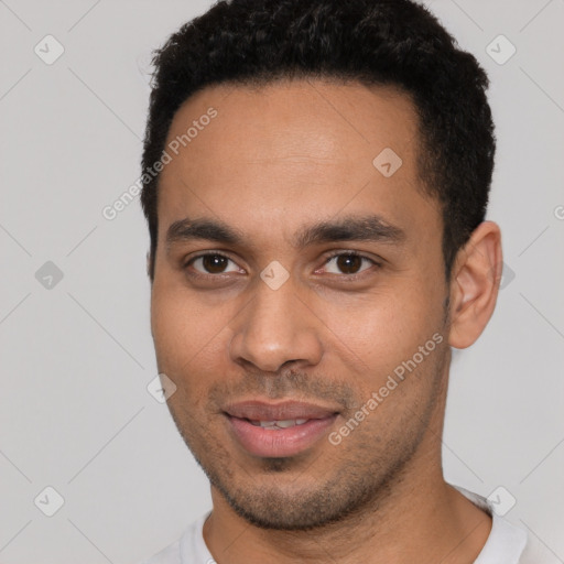 Joyful latino young-adult male with short  brown hair and brown eyes