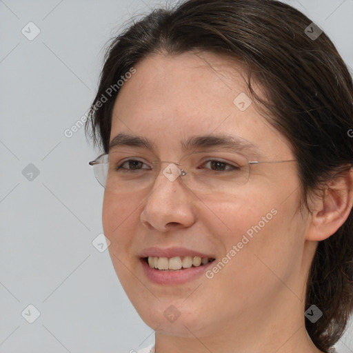 Joyful white adult female with medium  brown hair and brown eyes