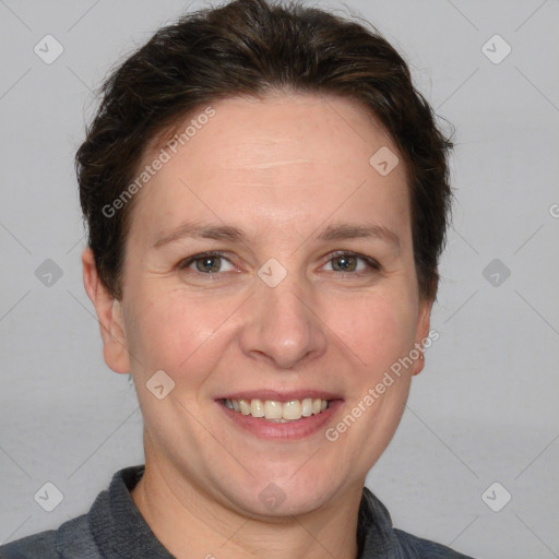 Joyful white adult female with short  brown hair and grey eyes