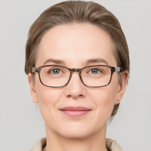 Joyful white young-adult female with medium  brown hair and grey eyes