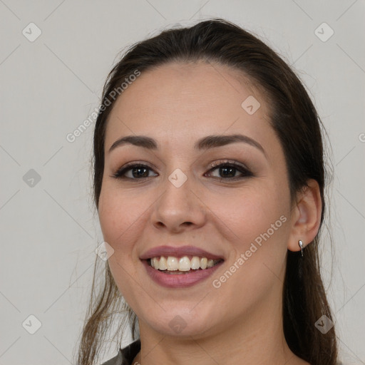 Joyful white young-adult female with long  brown hair and brown eyes