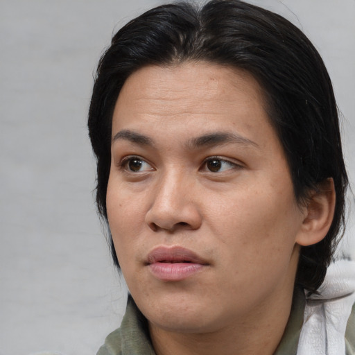 Neutral asian adult female with medium  brown hair and brown eyes