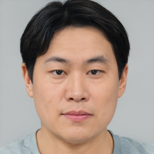 Neutral asian young-adult male with short  brown hair and brown eyes
