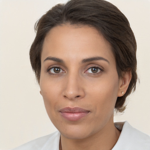 Joyful white young-adult female with medium  brown hair and brown eyes