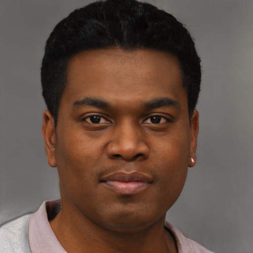 Joyful black young-adult male with short  black hair and brown eyes
