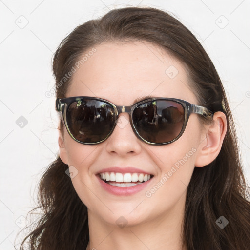 Joyful white young-adult female with long  brown hair and blue eyes