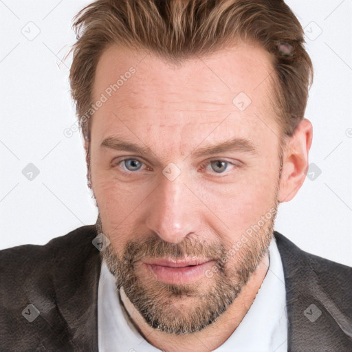 Joyful white adult male with short  brown hair and blue eyes