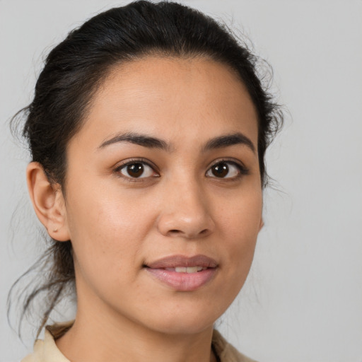 Joyful latino young-adult female with medium  brown hair and brown eyes