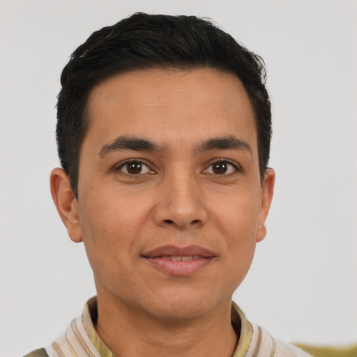 Joyful latino young-adult male with short  brown hair and brown eyes