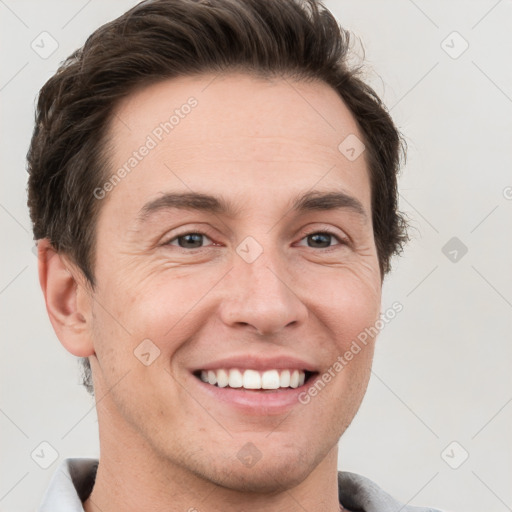 Joyful white adult male with short  brown hair and grey eyes