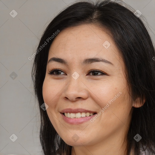 Joyful asian young-adult female with long  brown hair and brown eyes