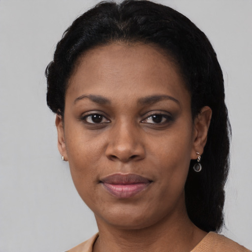 Joyful black young-adult female with short  black hair and brown eyes