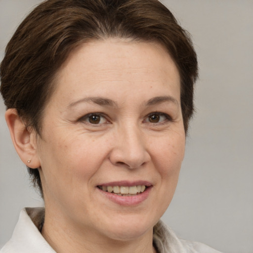 Joyful white adult female with medium  brown hair and brown eyes