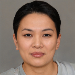 Joyful asian young-adult female with short  black hair and brown eyes