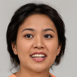 Joyful asian young-adult female with medium  brown hair and brown eyes