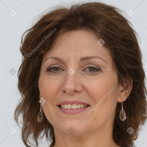 Joyful white adult female with long  brown hair and grey eyes