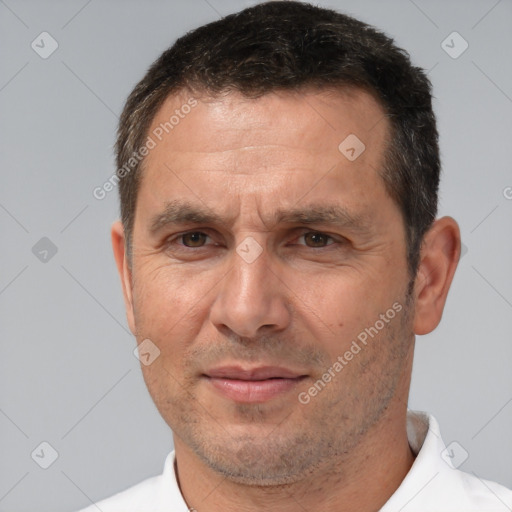 Joyful white adult male with short  brown hair and brown eyes