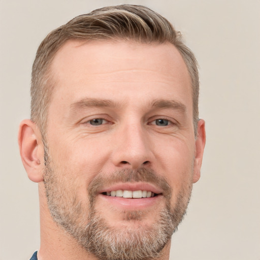 Joyful white adult male with short  brown hair and grey eyes