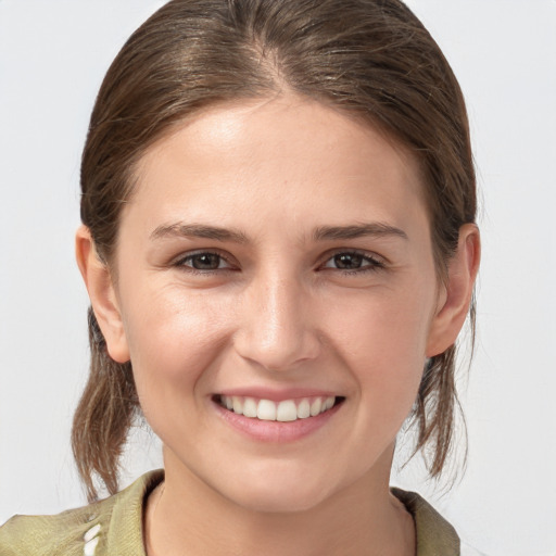 Joyful white young-adult female with medium  brown hair and grey eyes