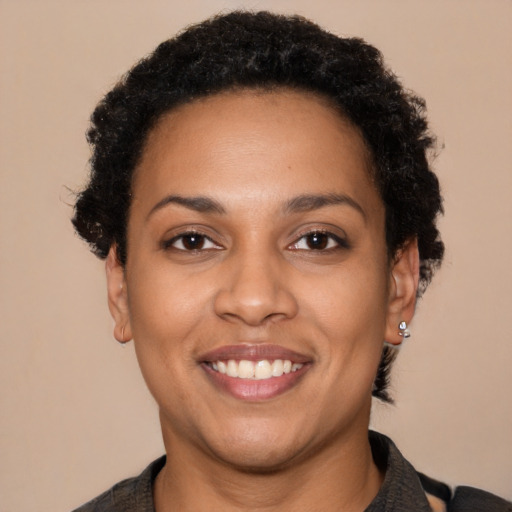 Joyful latino young-adult female with short  brown hair and brown eyes