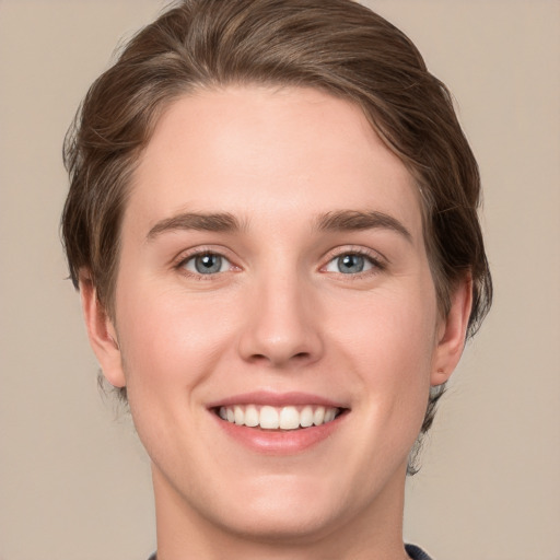 Joyful white young-adult female with short  brown hair and green eyes