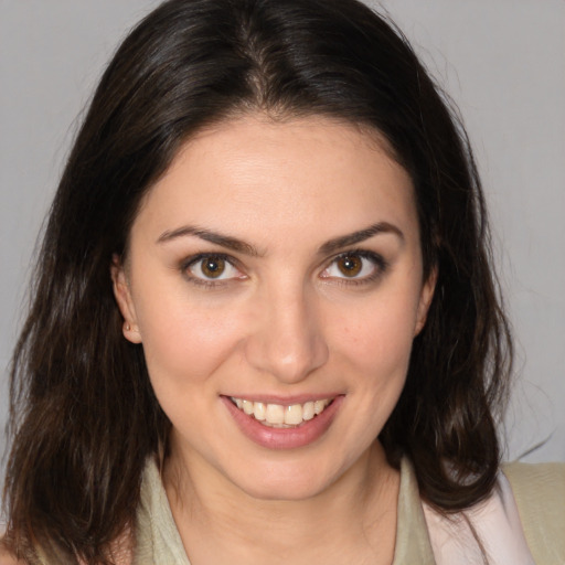 Joyful white young-adult female with medium  brown hair and brown eyes