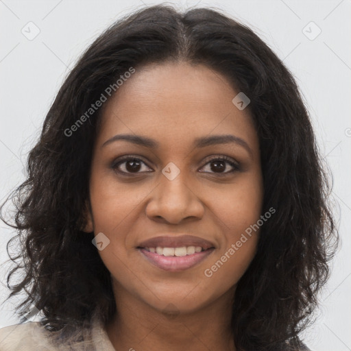 Joyful black young-adult female with long  brown hair and brown eyes