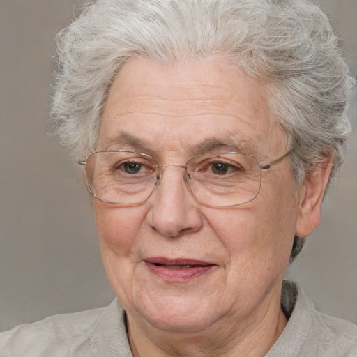 Joyful white middle-aged female with short  gray hair and blue eyes