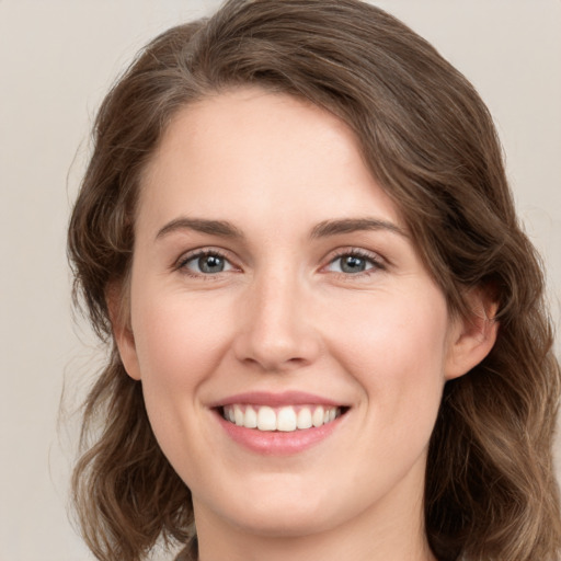 Joyful white young-adult female with medium  brown hair and green eyes