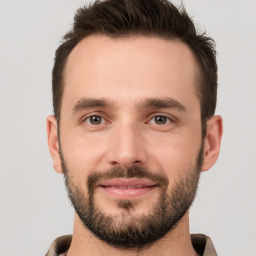 Joyful white young-adult male with short  brown hair and brown eyes