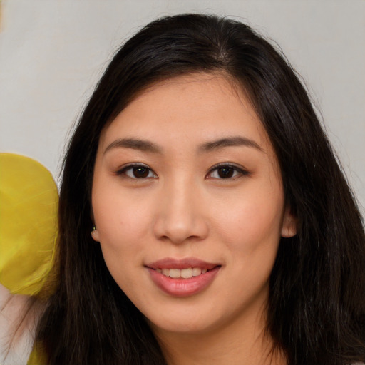 Joyful asian young-adult female with long  brown hair and brown eyes