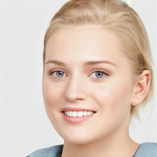 Joyful white young-adult female with medium  brown hair and blue eyes