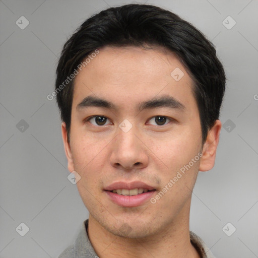 Joyful asian young-adult male with short  black hair and brown eyes