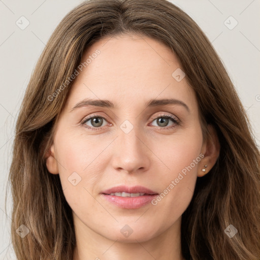 Joyful white young-adult female with long  brown hair and green eyes