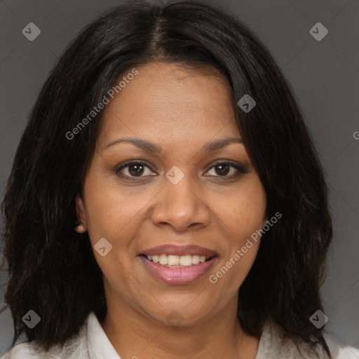 Joyful black adult female with medium  brown hair and brown eyes