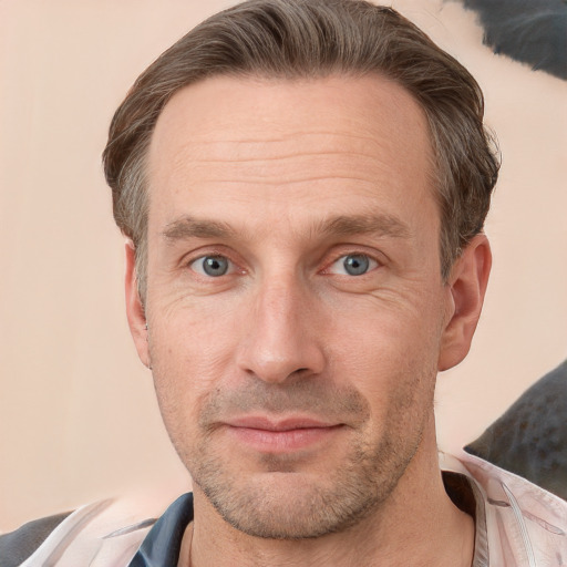 Joyful white adult male with short  brown hair and grey eyes