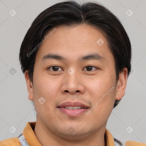 Joyful asian young-adult male with short  brown hair and brown eyes