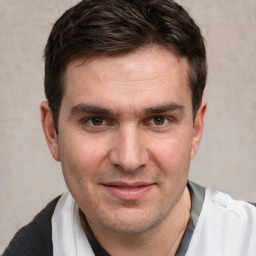 Joyful white young-adult male with short  brown hair and brown eyes