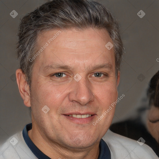 Joyful white middle-aged male with short  brown hair and brown eyes