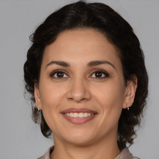 Joyful white adult female with medium  brown hair and brown eyes